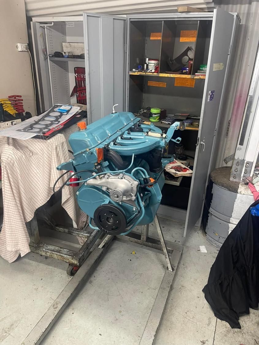 A Blue Engine is Sitting in a Cabinet in a Garage — Currie Bros Engine Reconditioners in Gloucester, NSW