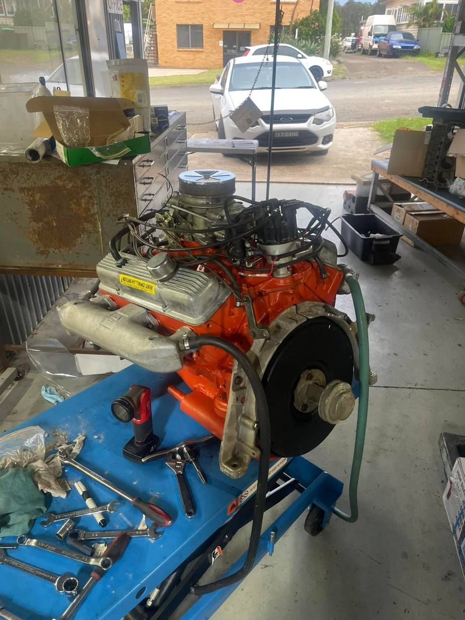 A Car Engine is Sitting on Top of a Blue Table in a Garage — Currie Bros Engine Reconditioners in Laurieton, NSW