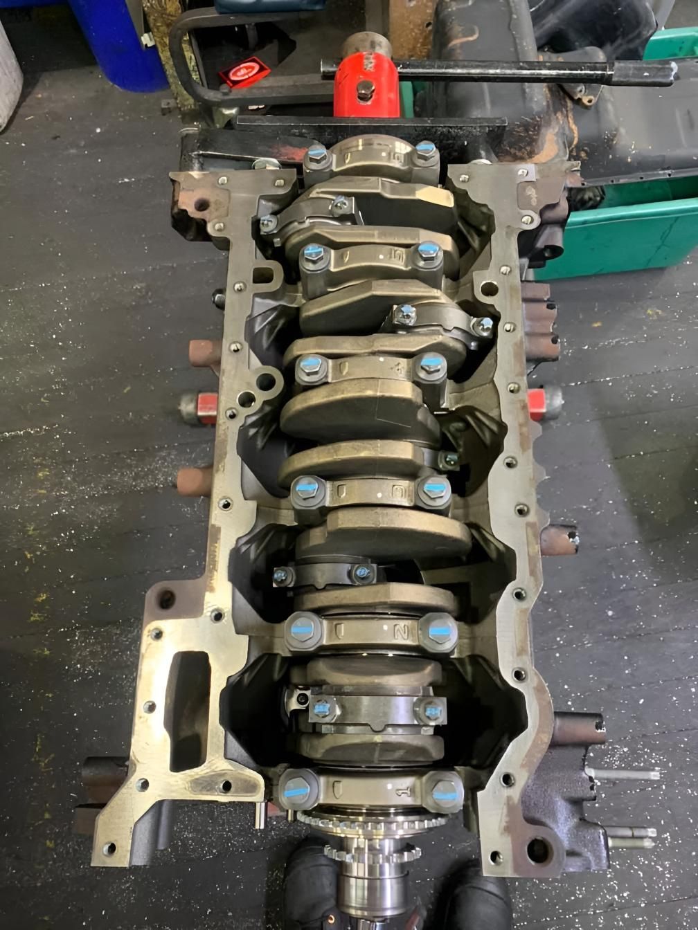 The Crankshaft of a Car Engine is Being Worked on in a Garage — Currie Bros Engine Reconditioners in Taree, NSW