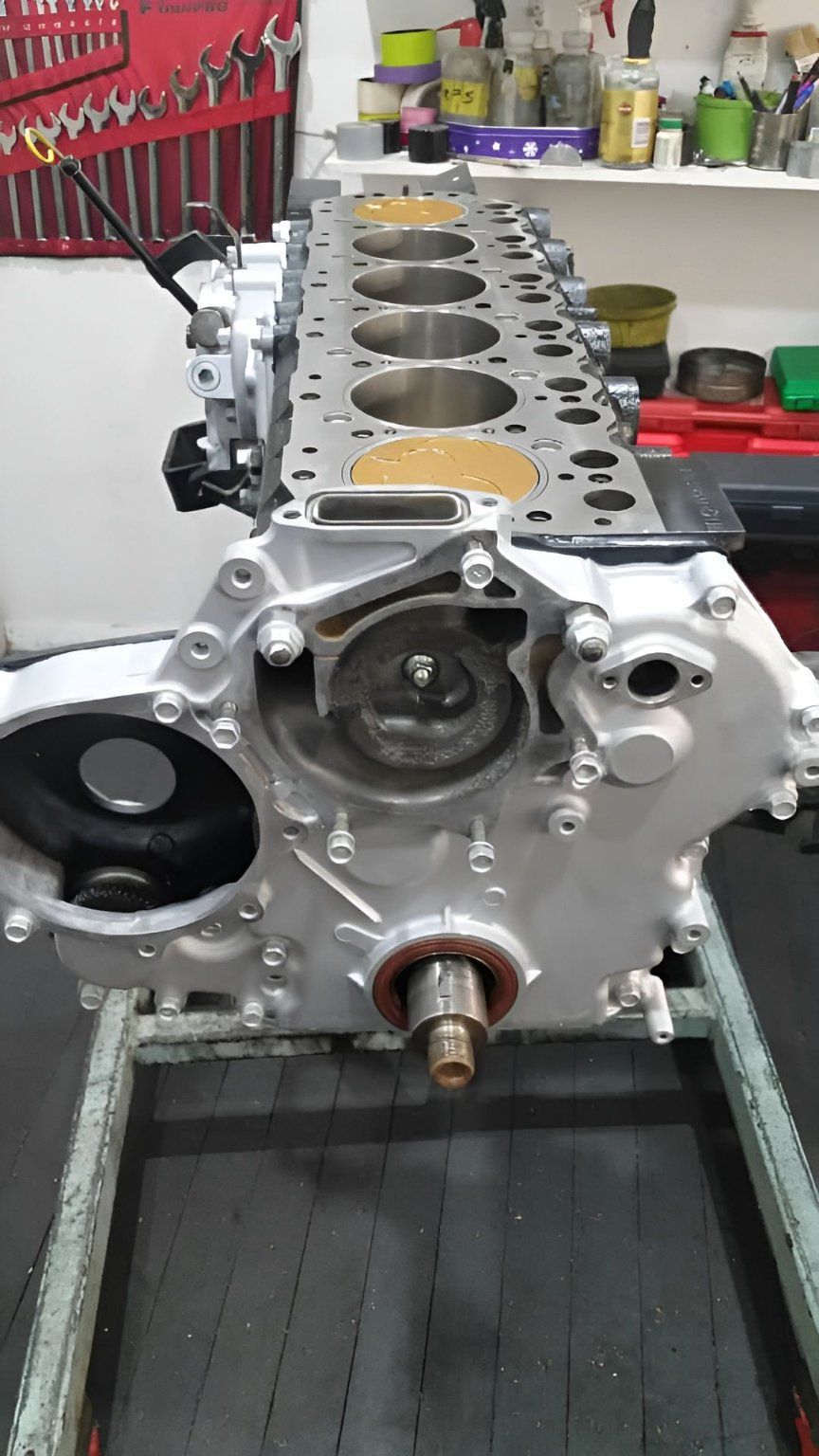 A Car Engine is Sitting on a Table in a Garage — Currie Bros Engine Reconditioners in Forster, NSW