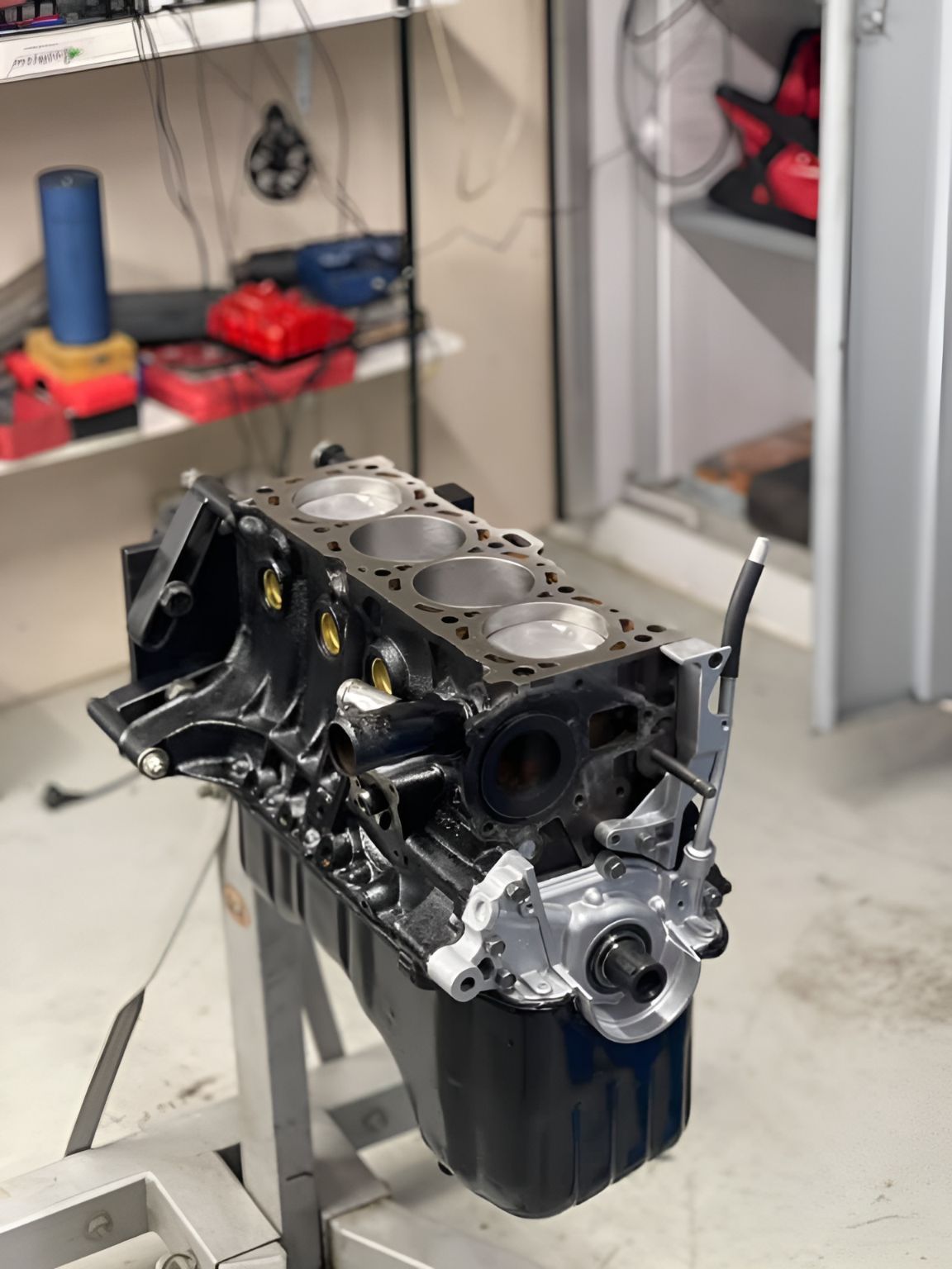 A Black Engine Block is Sitting on Top of a Metal Stand — Currie Bros Engine Reconditioners in Wauchope, NSW