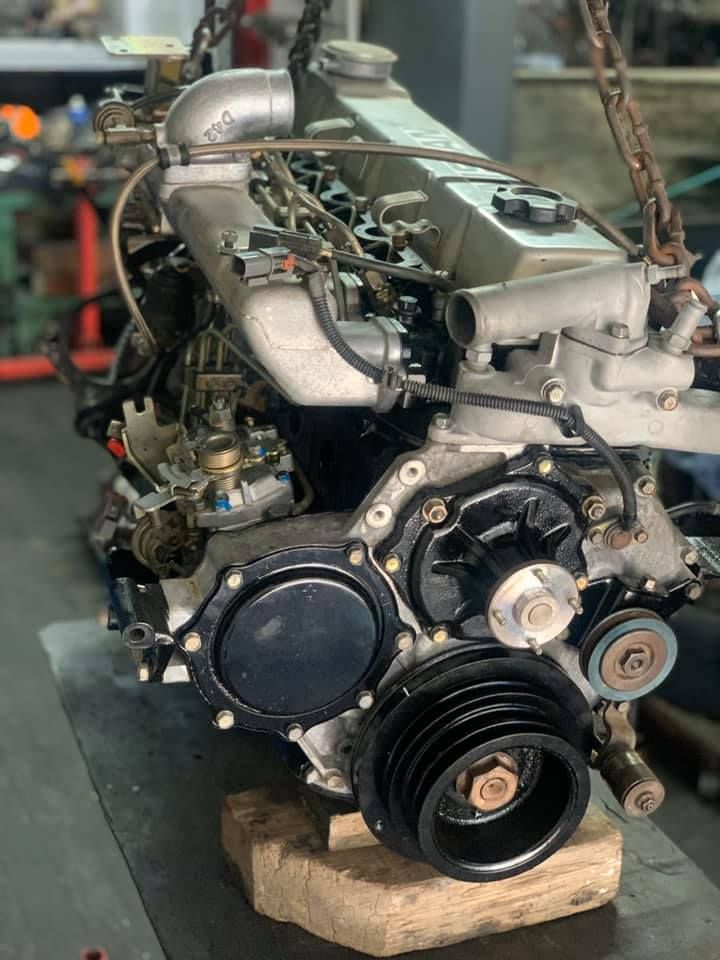 A Large Engine is Sitting on Top of a Wooden Block on a Table — Currie Bros Engine Reconditioners in Taree, NSW