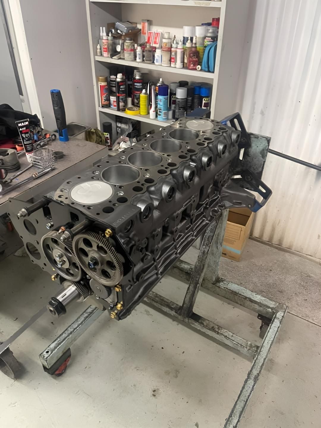 A Large Engine is Sitting on Top of a Table in a Garage — Currie Bros Engine Reconditioners in Coffs Harbour, NSW