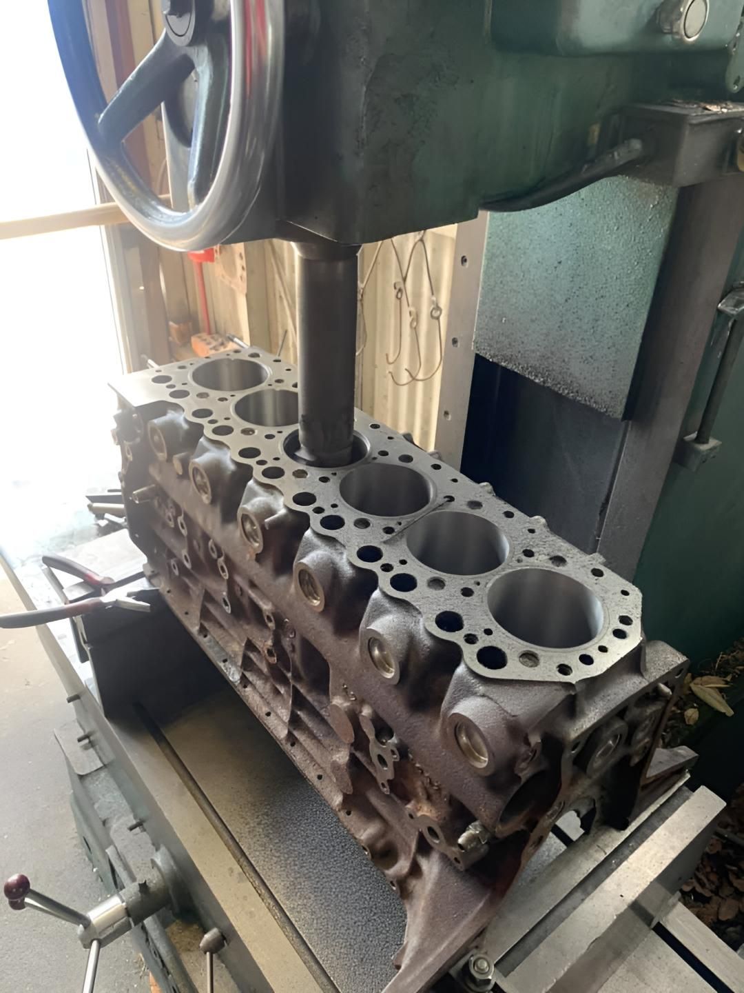 A Cylinder Block is Being Worked on by a Machine — Currie Bros Engine Reconditioners in Port Macquarie, NSW