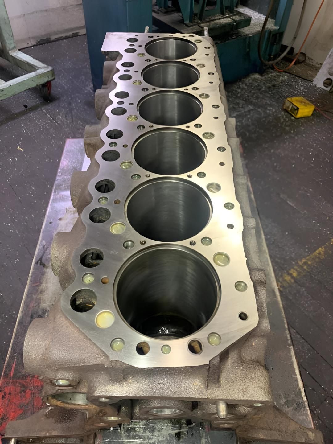 A Cylinder Block is Sitting on Top of a Metal Table — Currie Bros Engine Reconditioners in Port Macquarie, NSW