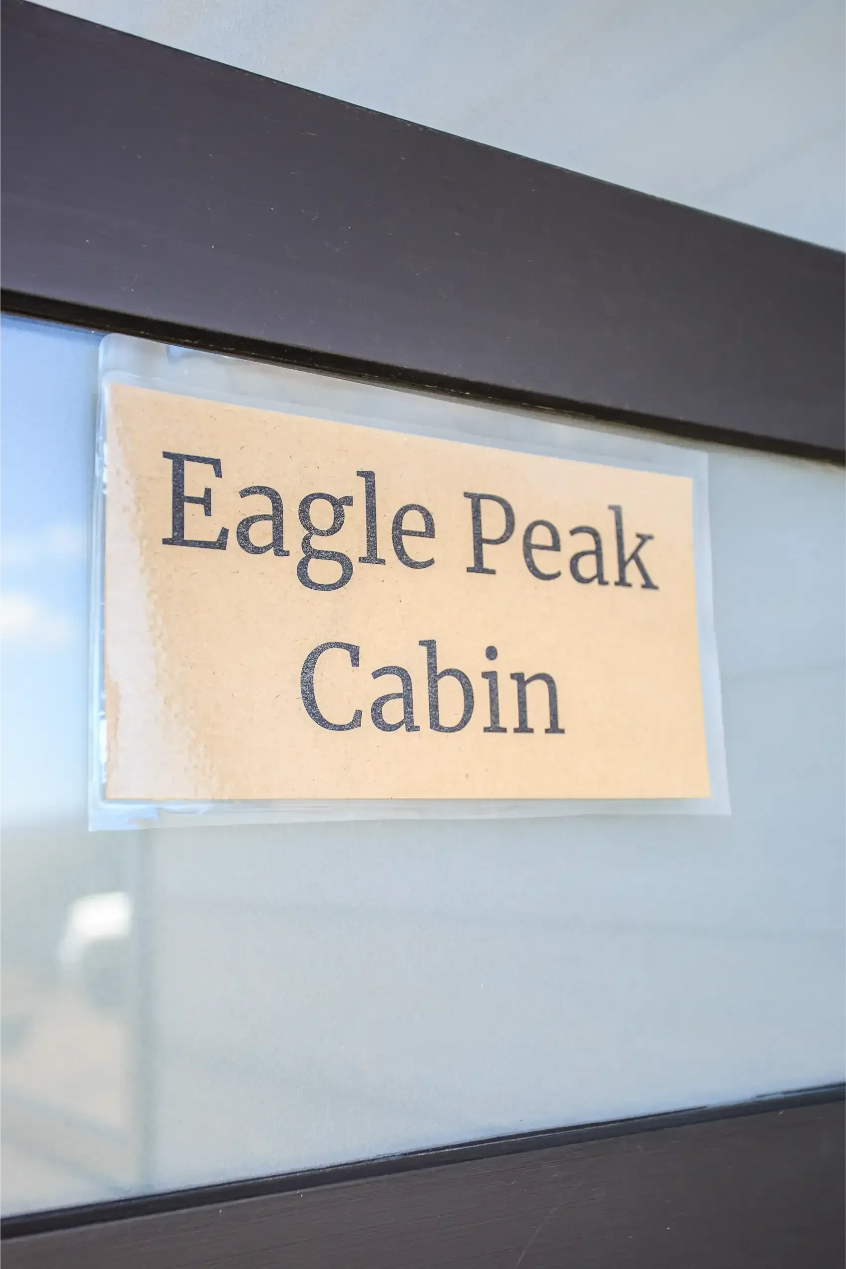 A sign taped to a glass door that reads 