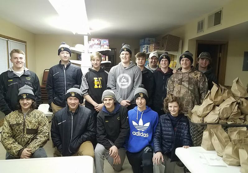 A group of young men are posing for a picture in a room.