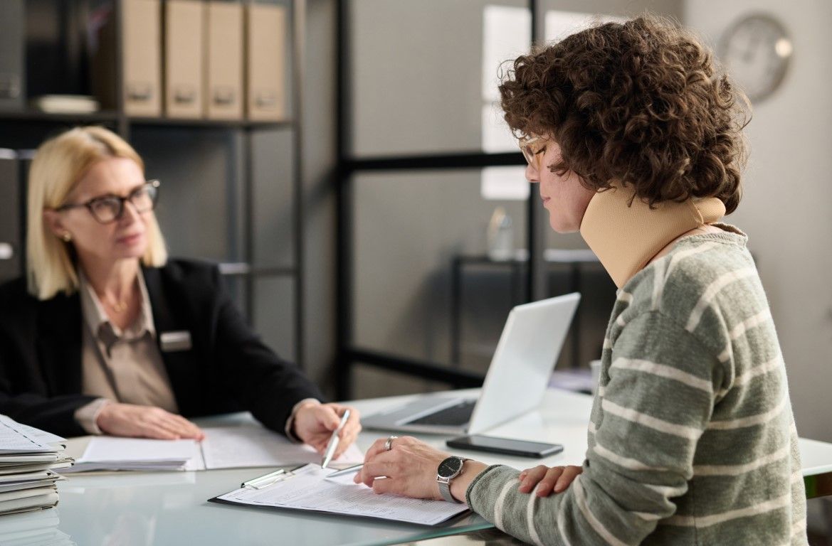 An image of an injured woman consulting with an attorney.