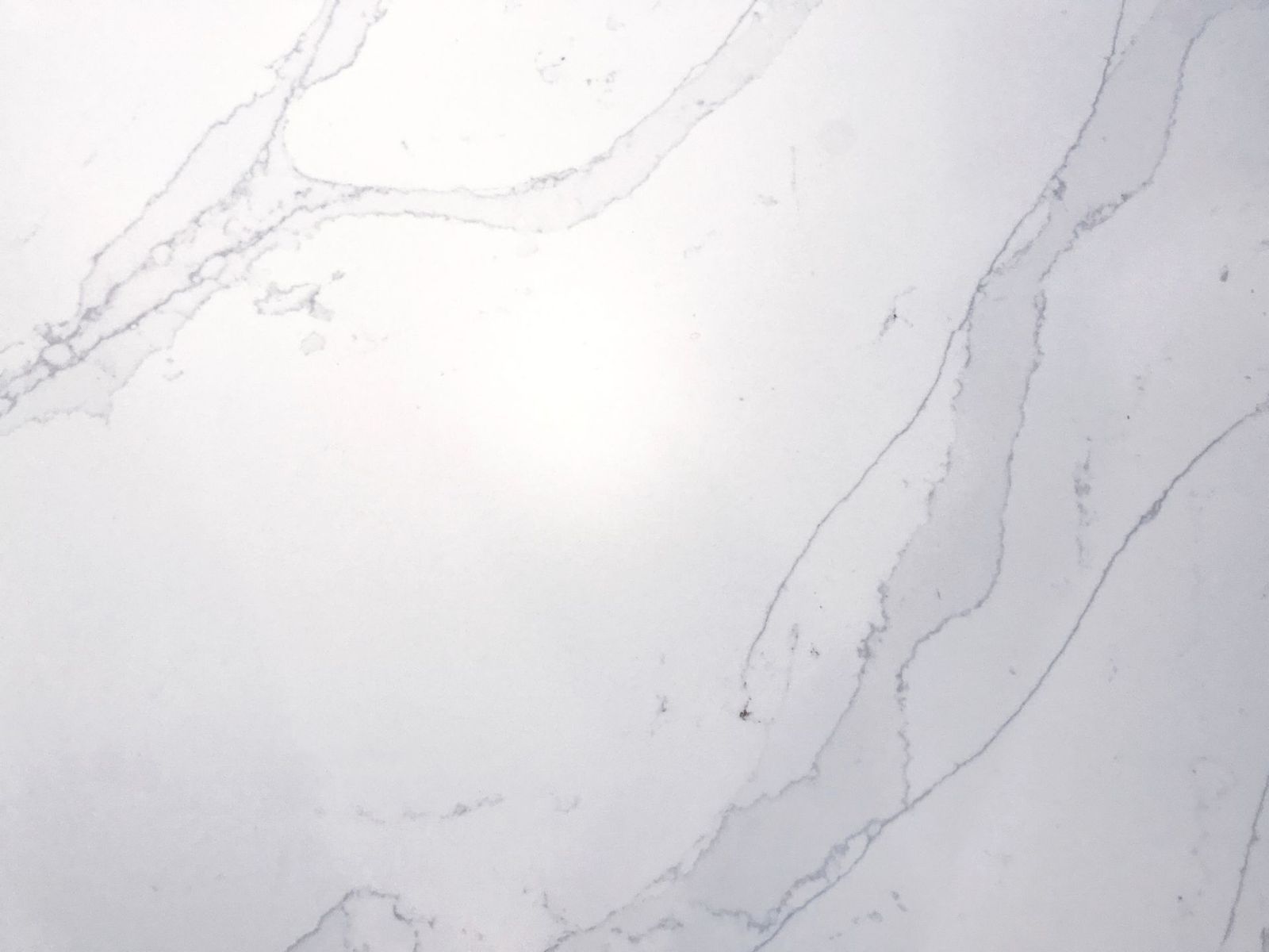 White marble surface with subtle grey veining.