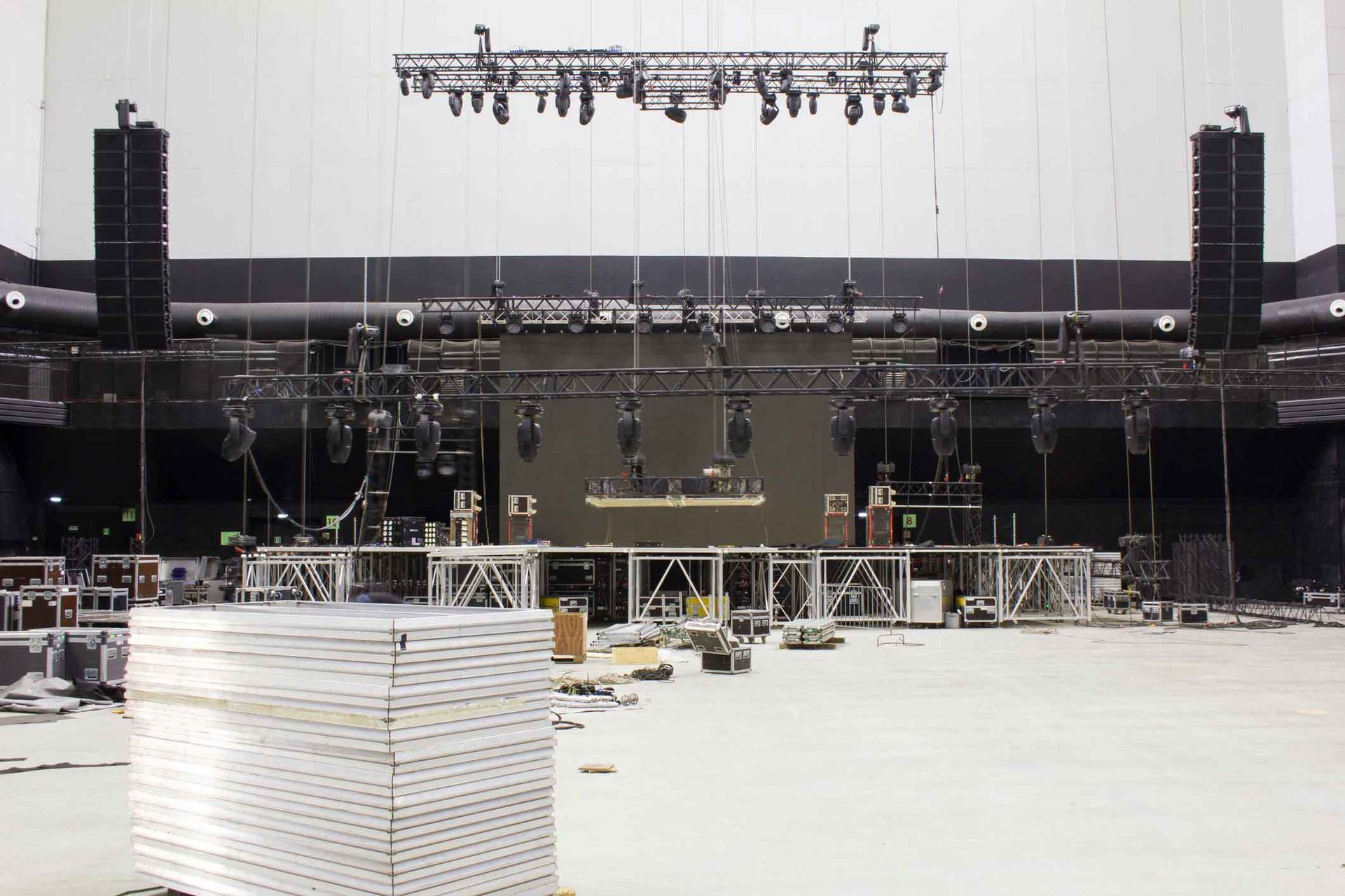 A stage is being built in a large auditorium