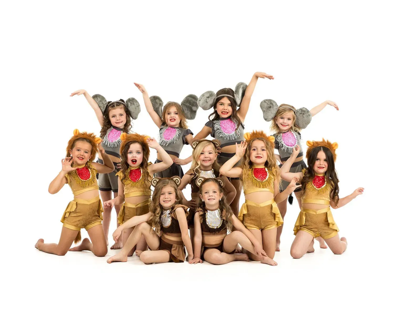 A group of young girls in elephant costumes are posing for a picture.