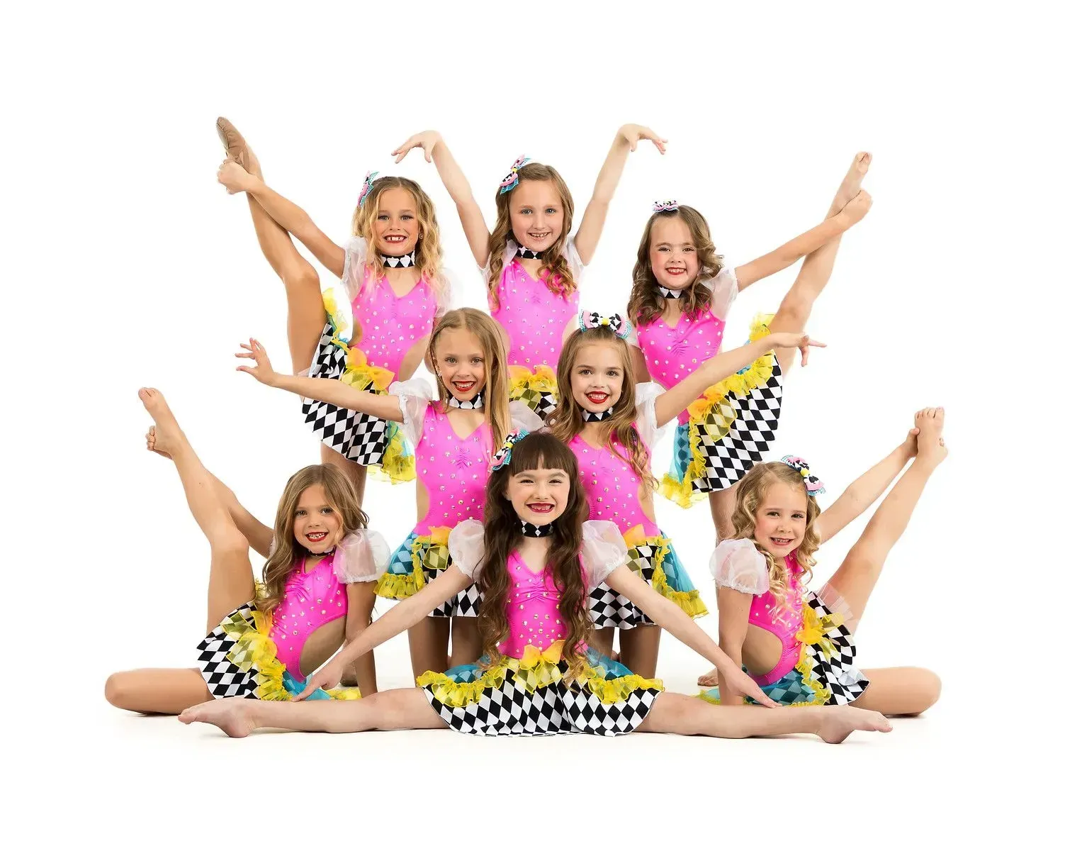 A group of young girls are posing for a picture.