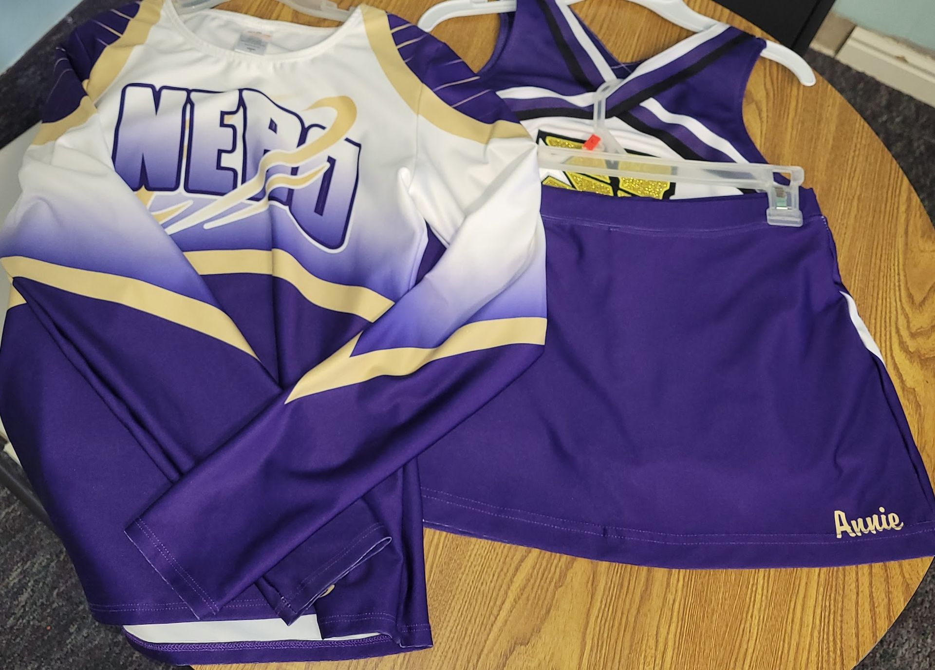 A purple and white cheer uniform with the word nerd on it