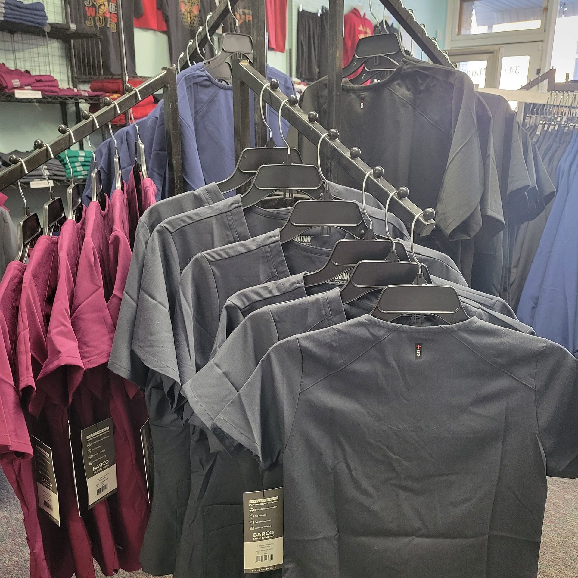 A bunch of shirts are hanging on a rack in a store