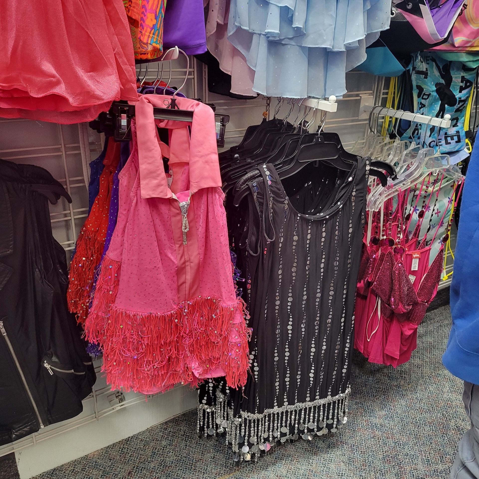 A bunch of clothes are hanging on a rack in a store