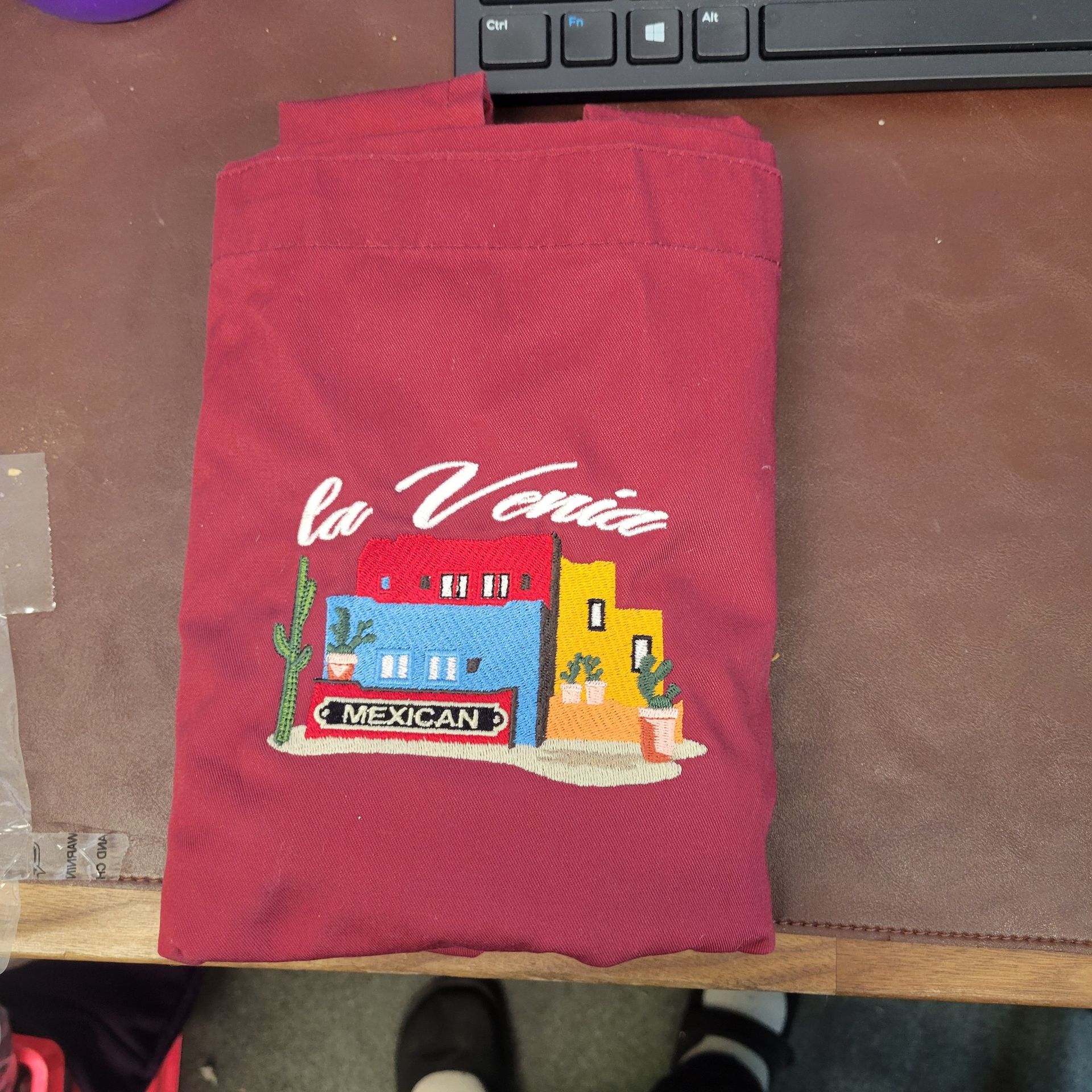 A red shirt with la voce embroidered on it