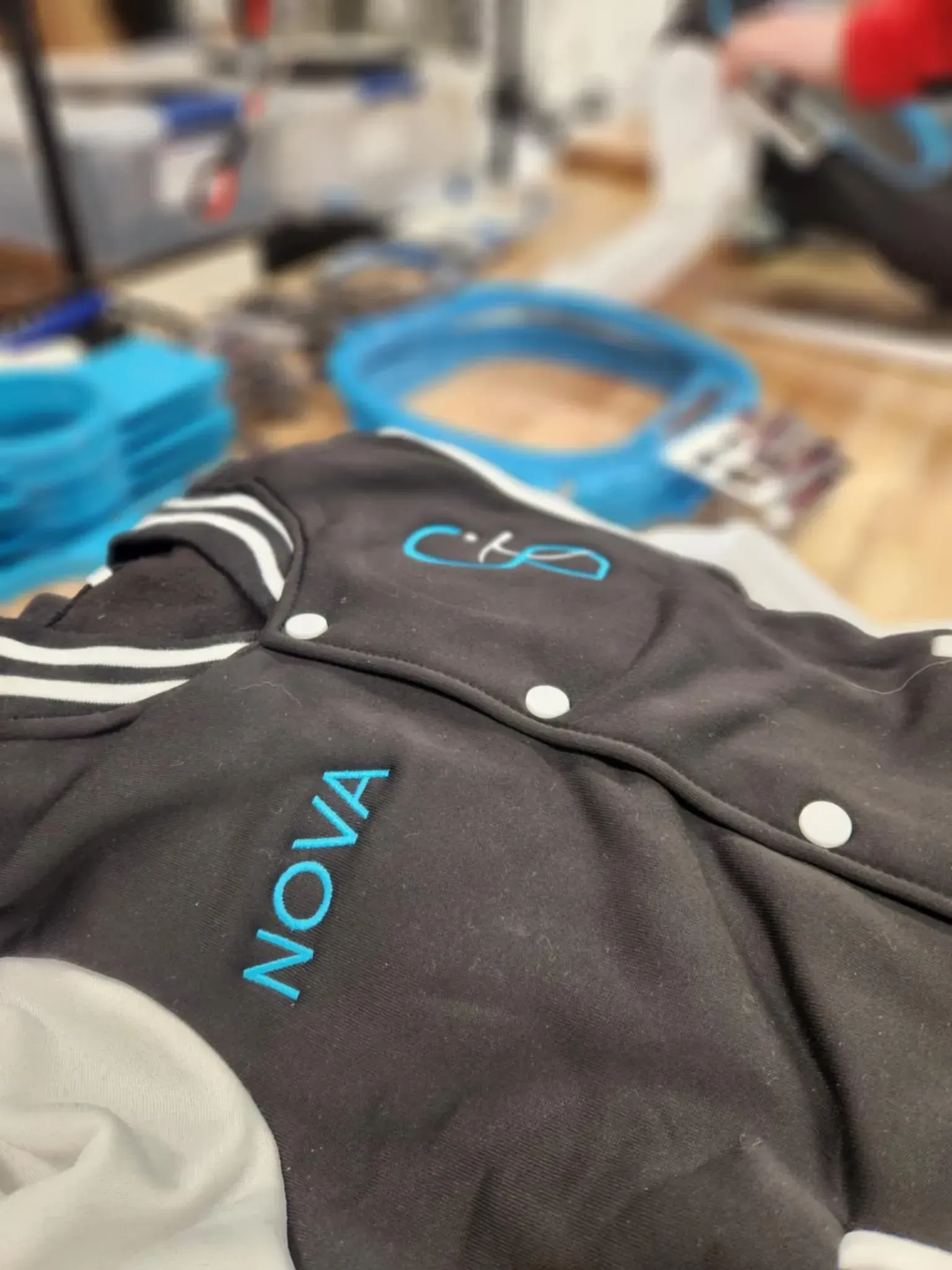 A black jacket with the word nova embroidered on it