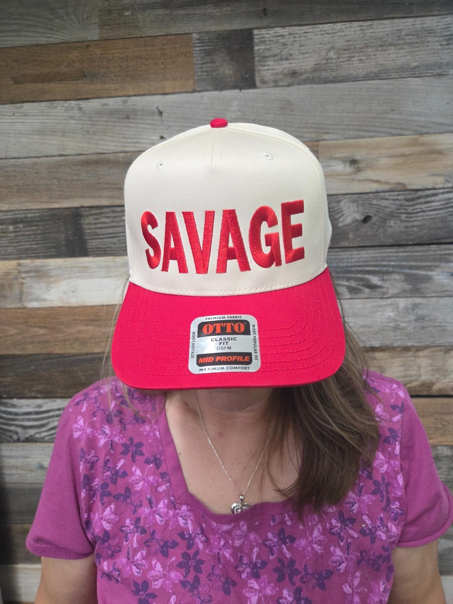 Woman wearing a red and white baseball cap with 