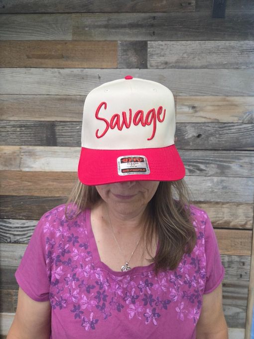 Woman wearing a cream and red hat with