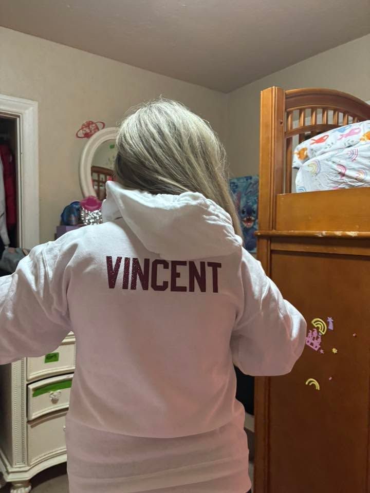 Person wearing a white hoodie with 