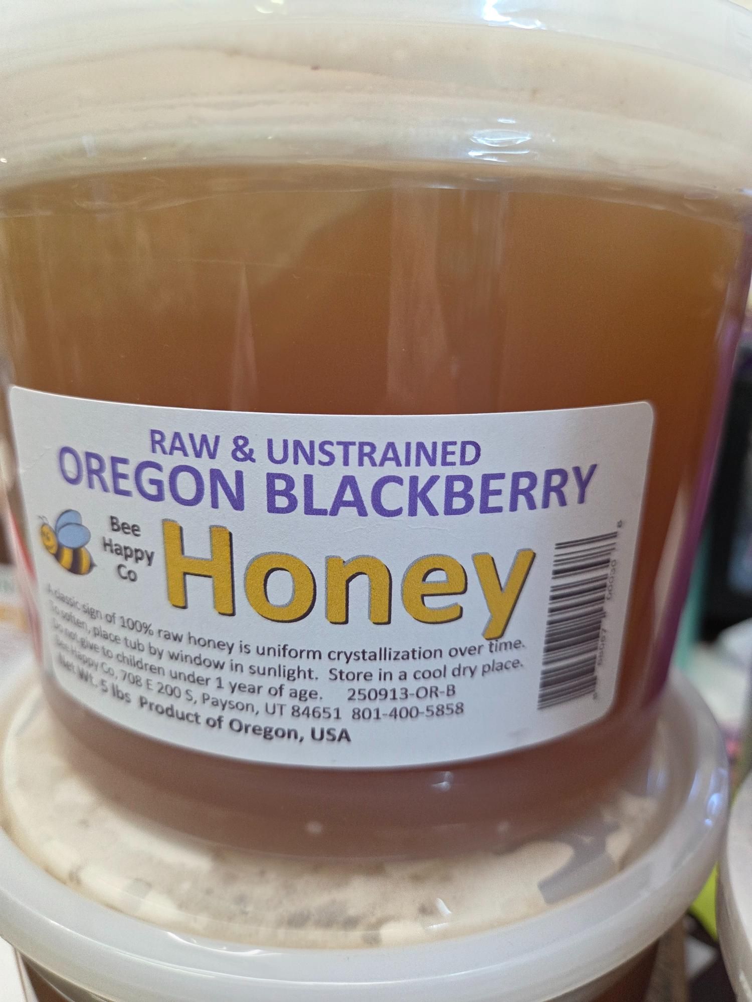 Bucket of raw, unstrained Oregon Blackberry honey with label and yellow text.