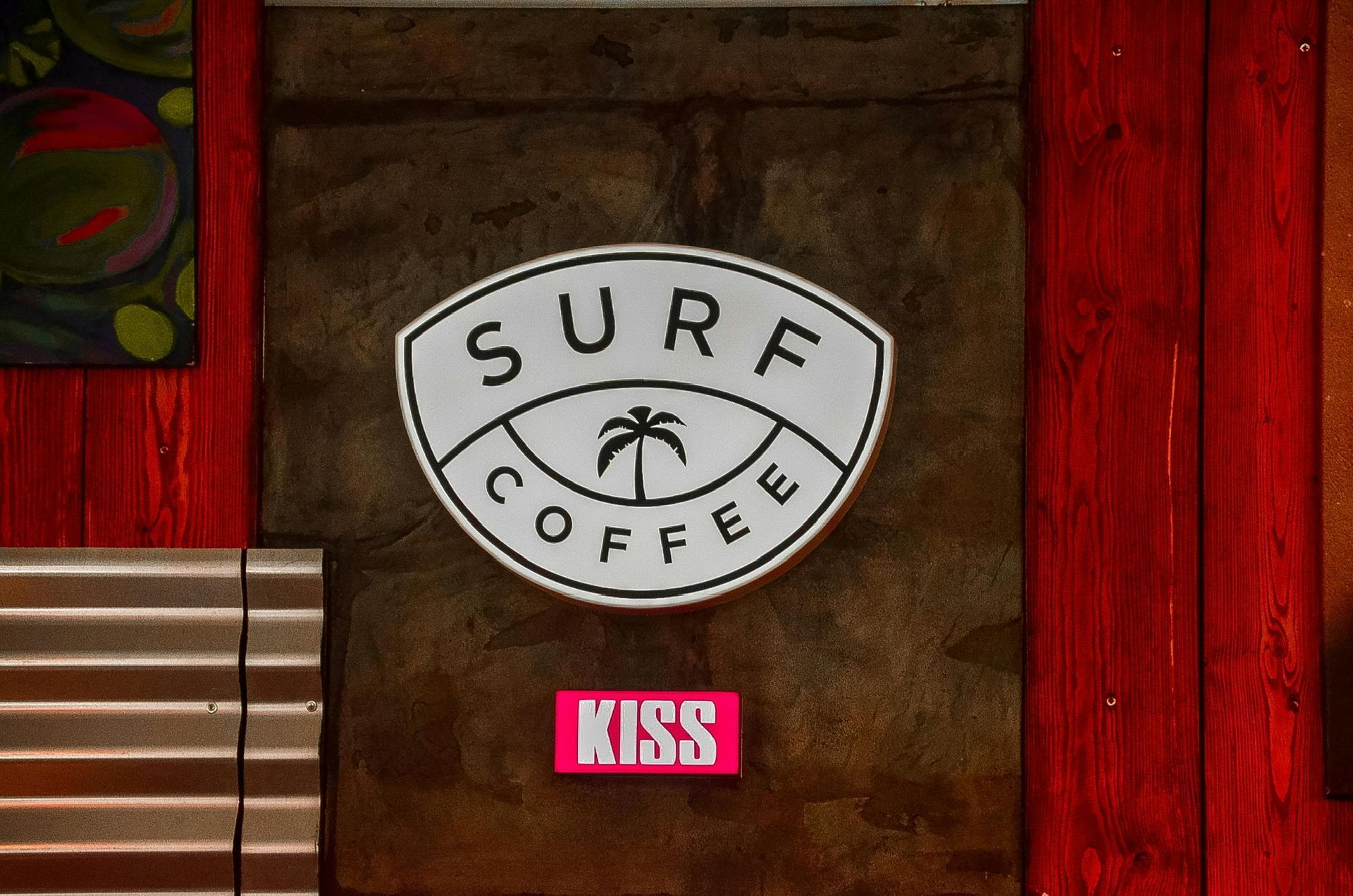 A sign for surf coffee with a palm tree on it