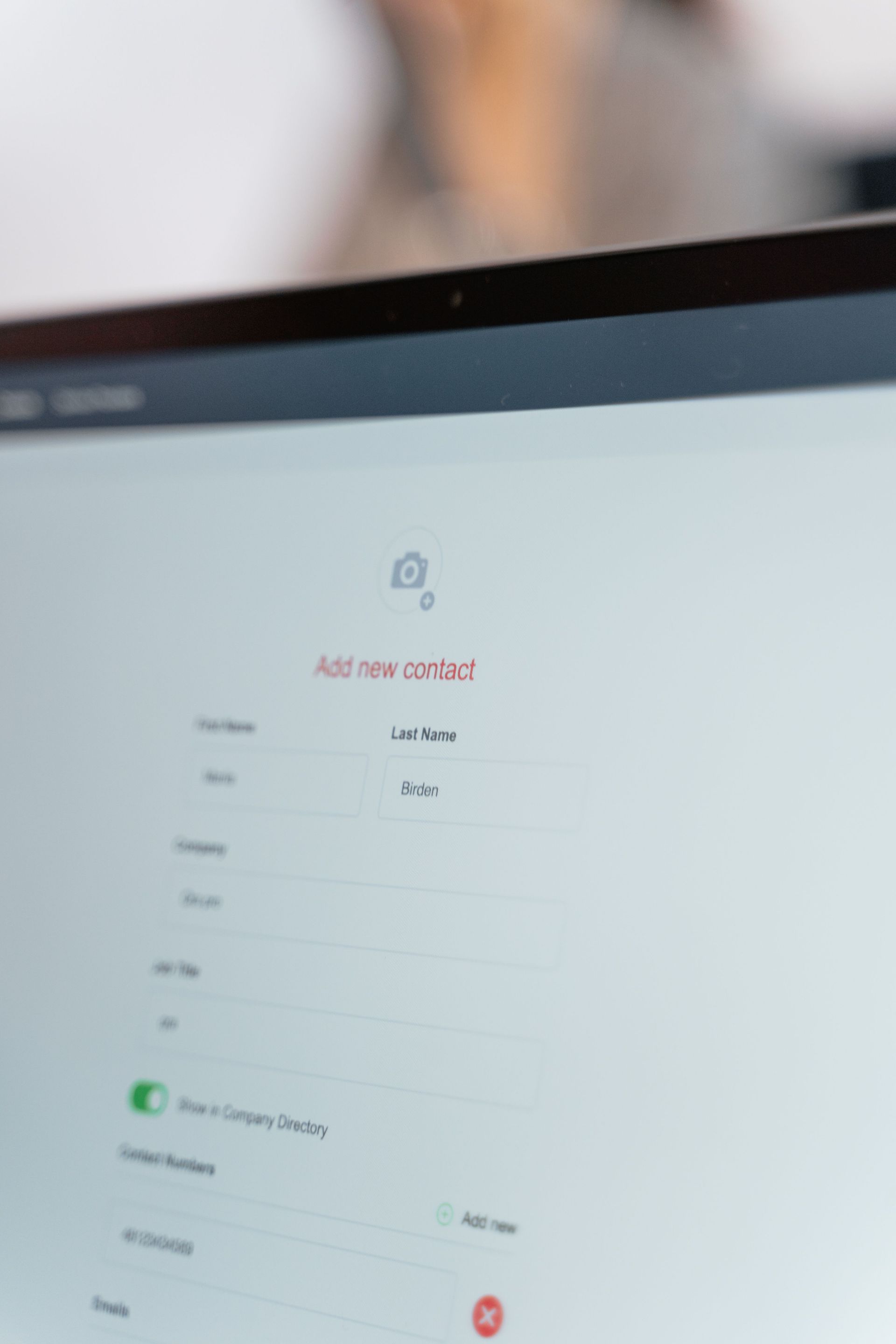 Blurred laptop screen showing a clean white login form with a lock icon and text fields