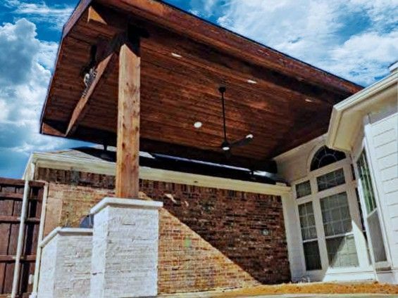 A house with a wooden roof and a ceiling fan.