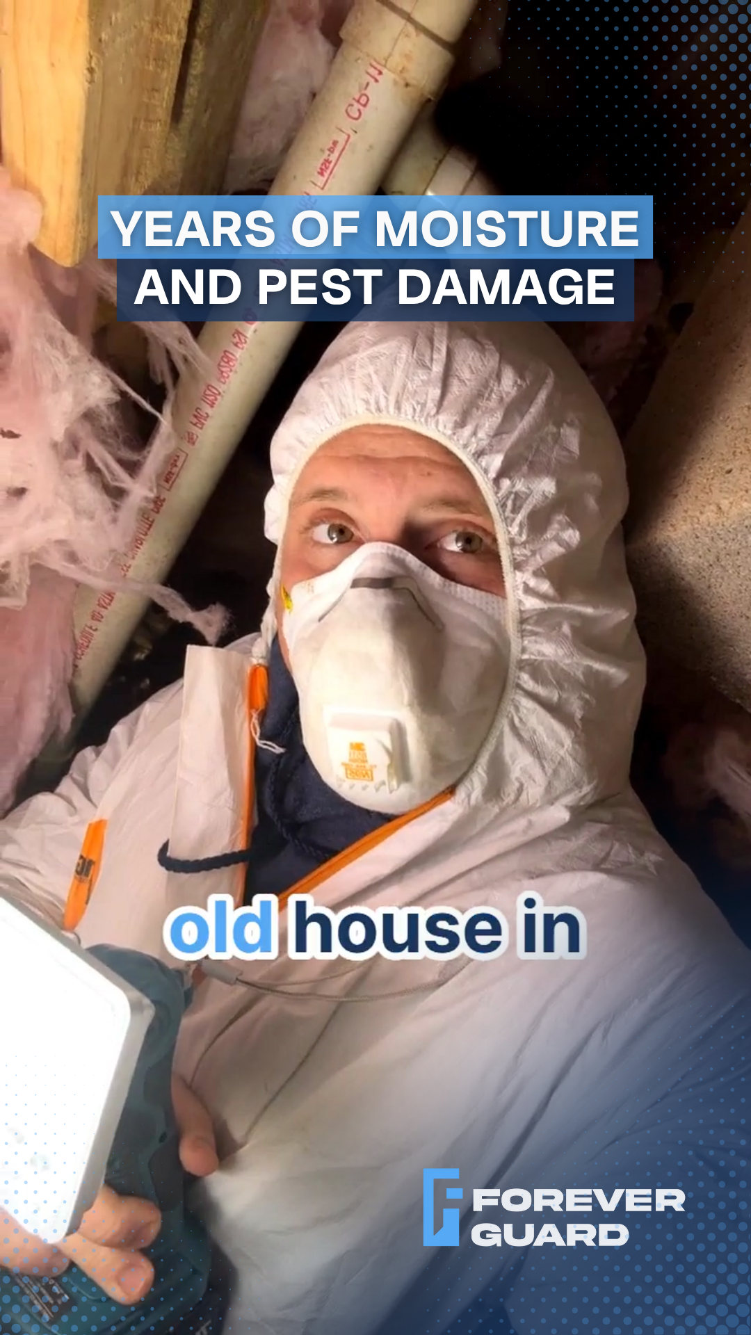Person in protective suit inspecting an attic with moisture and pest damage in an old house.
