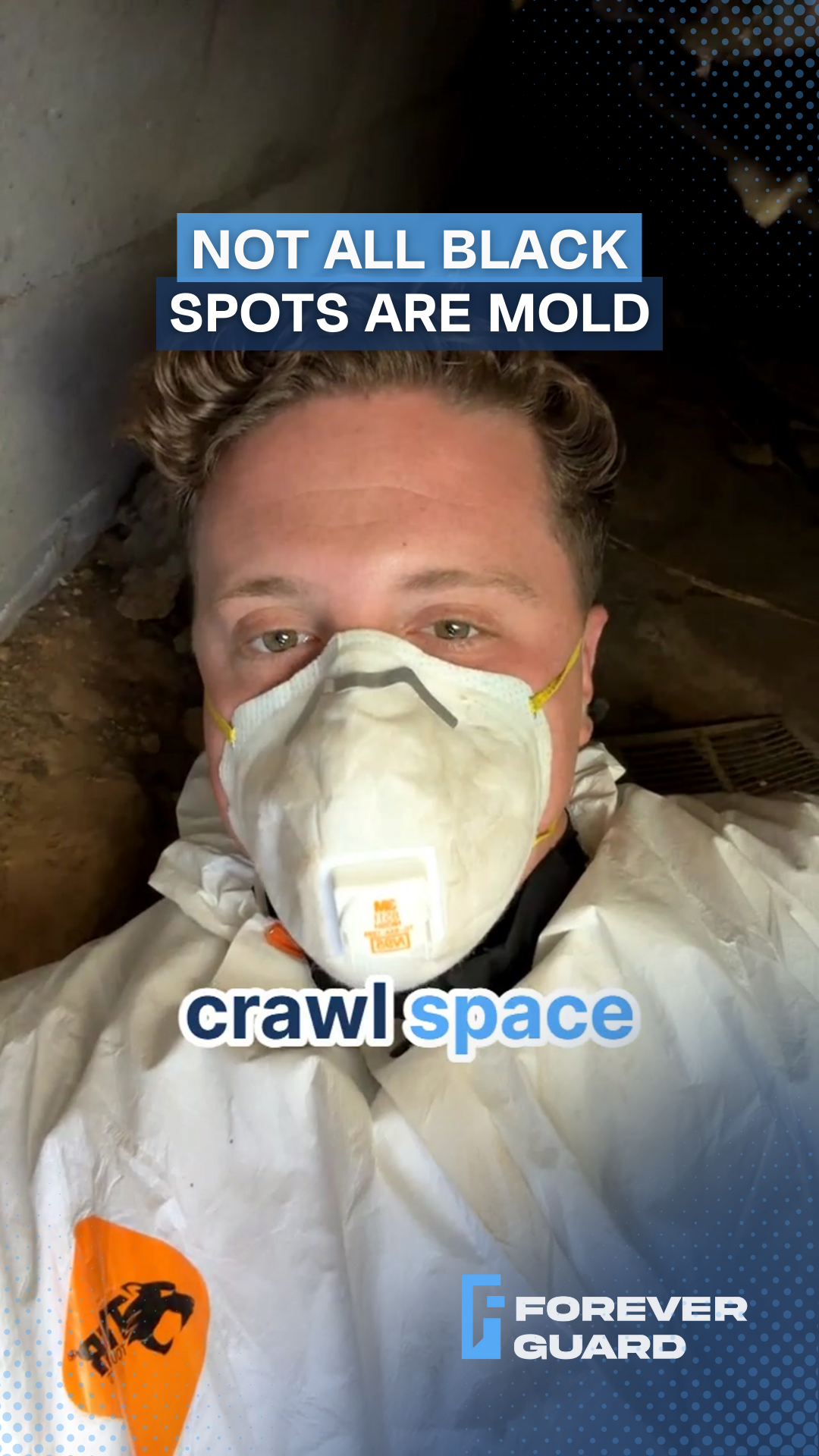 Man in a crawlspace wearing a mask, text reads 