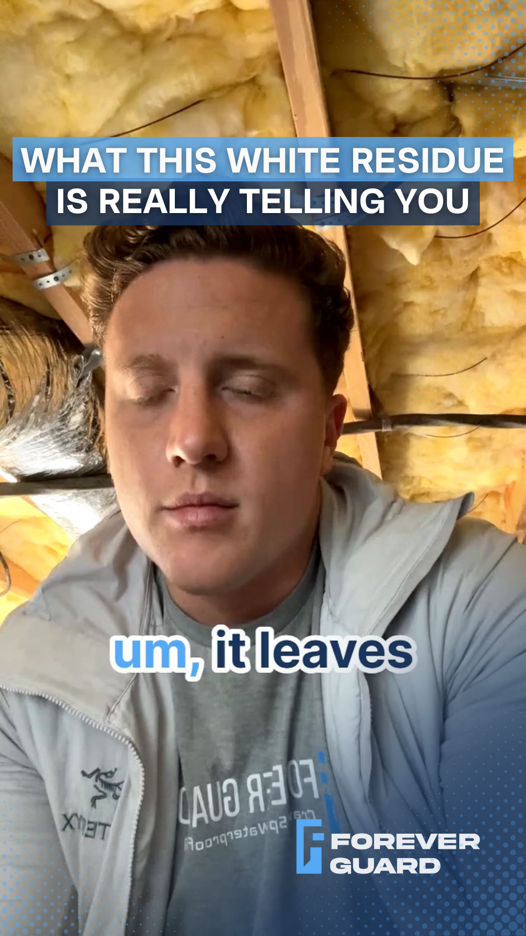 Man in a light jacket talks in an attic with a white residue. Text: 