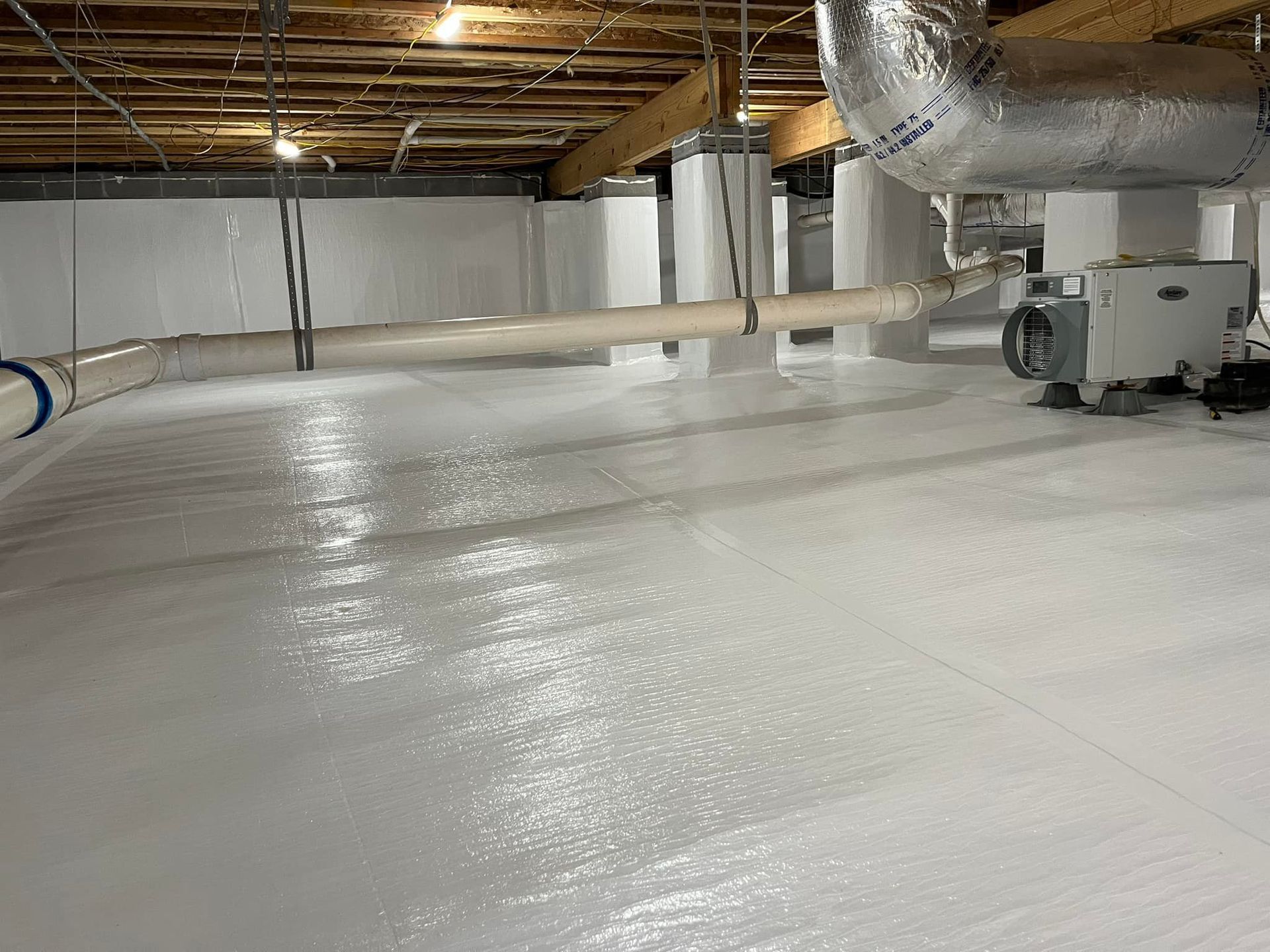 Finished crawlspace with white vapor barrier covering floor and walls. HVAC and ductwork visible.