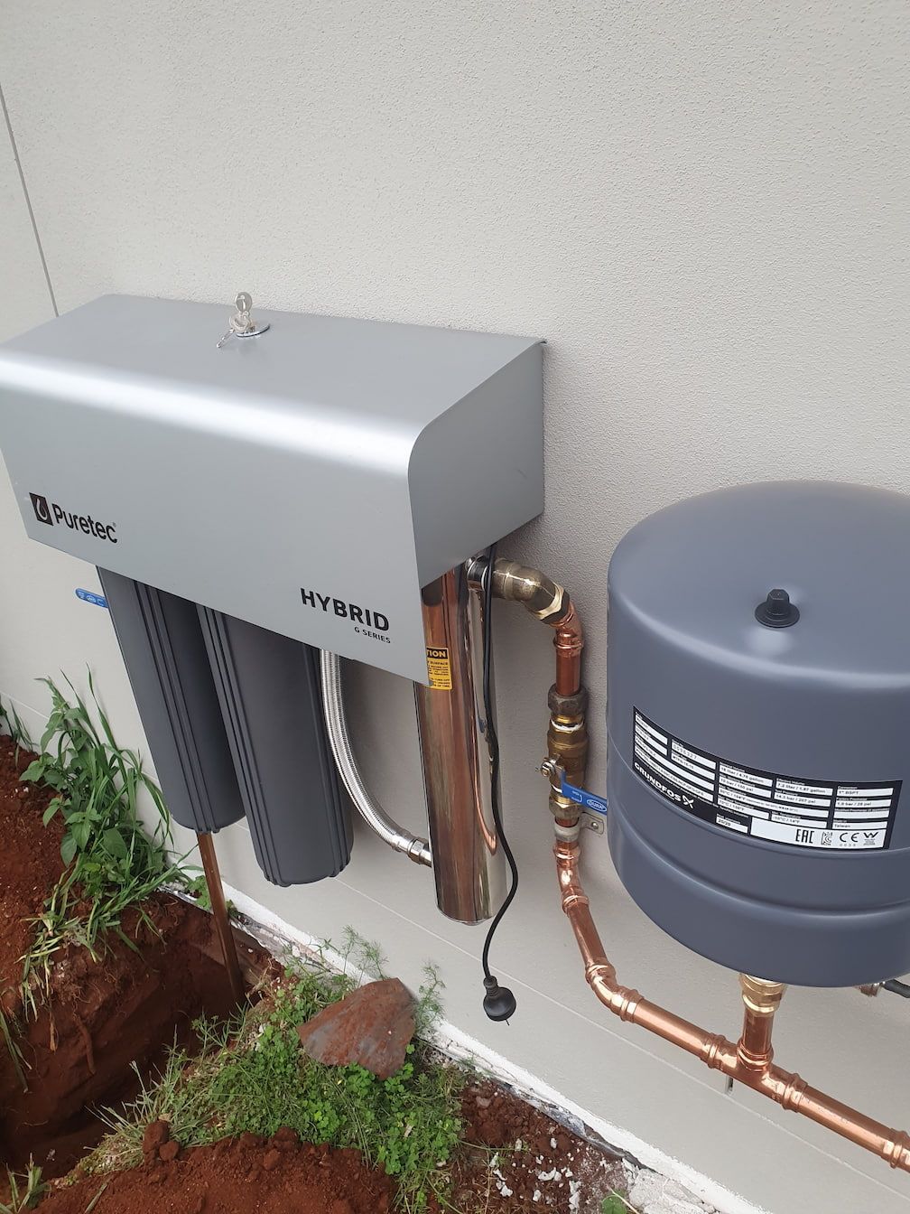 Puretec Plumbing Installed On A House Wall — Grant Wannan Plumbing in Wollongbar, NSW
