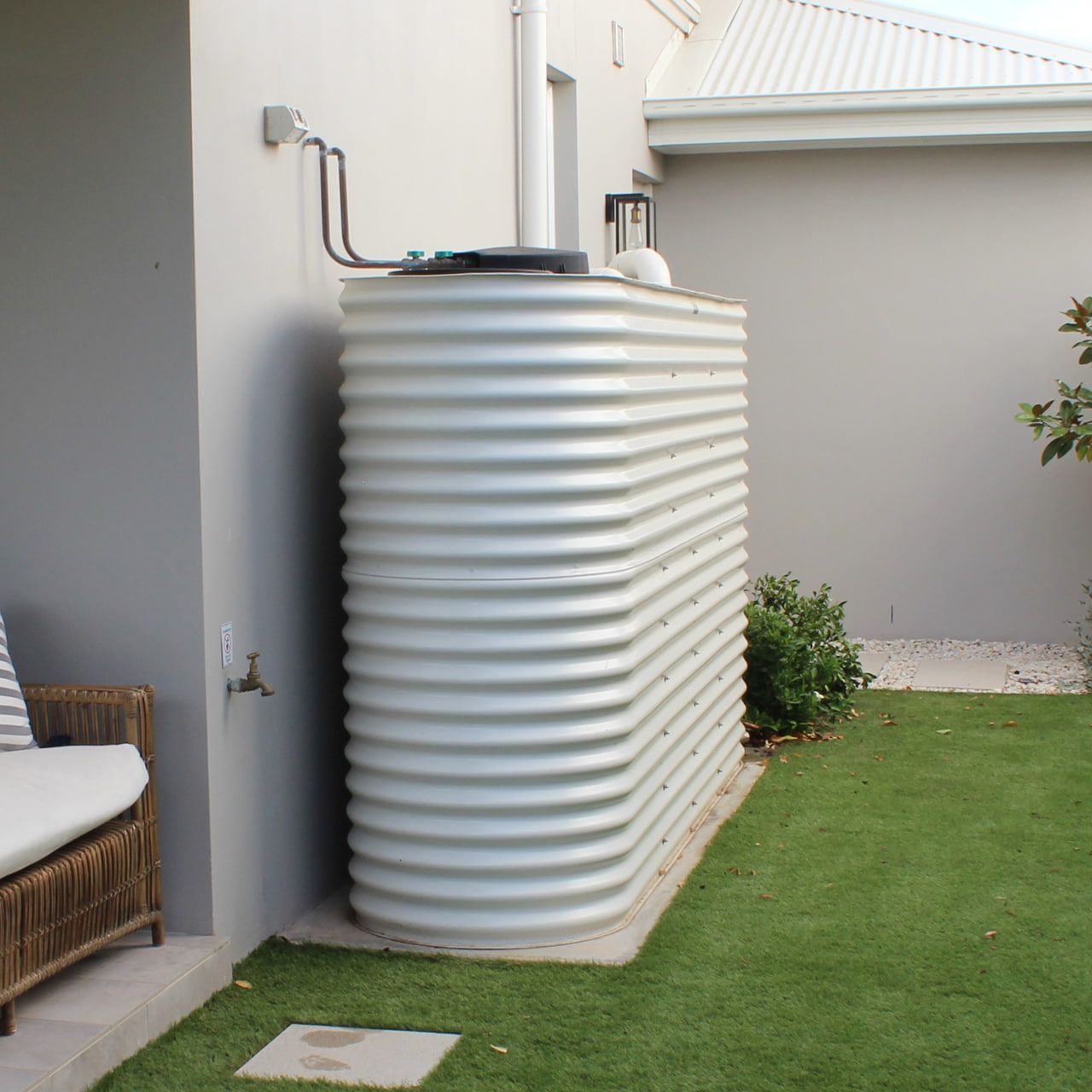 Two White Water Tanks Are Sitting Next to Each Other — Grant Wannan Plumbing in Wollongbar, NSW