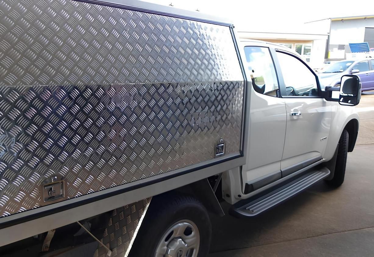 A White Truck With a Stainless Steel Canopy is Parked on the Side of the Road — Eclipse Fabrication in Atherton, QLD