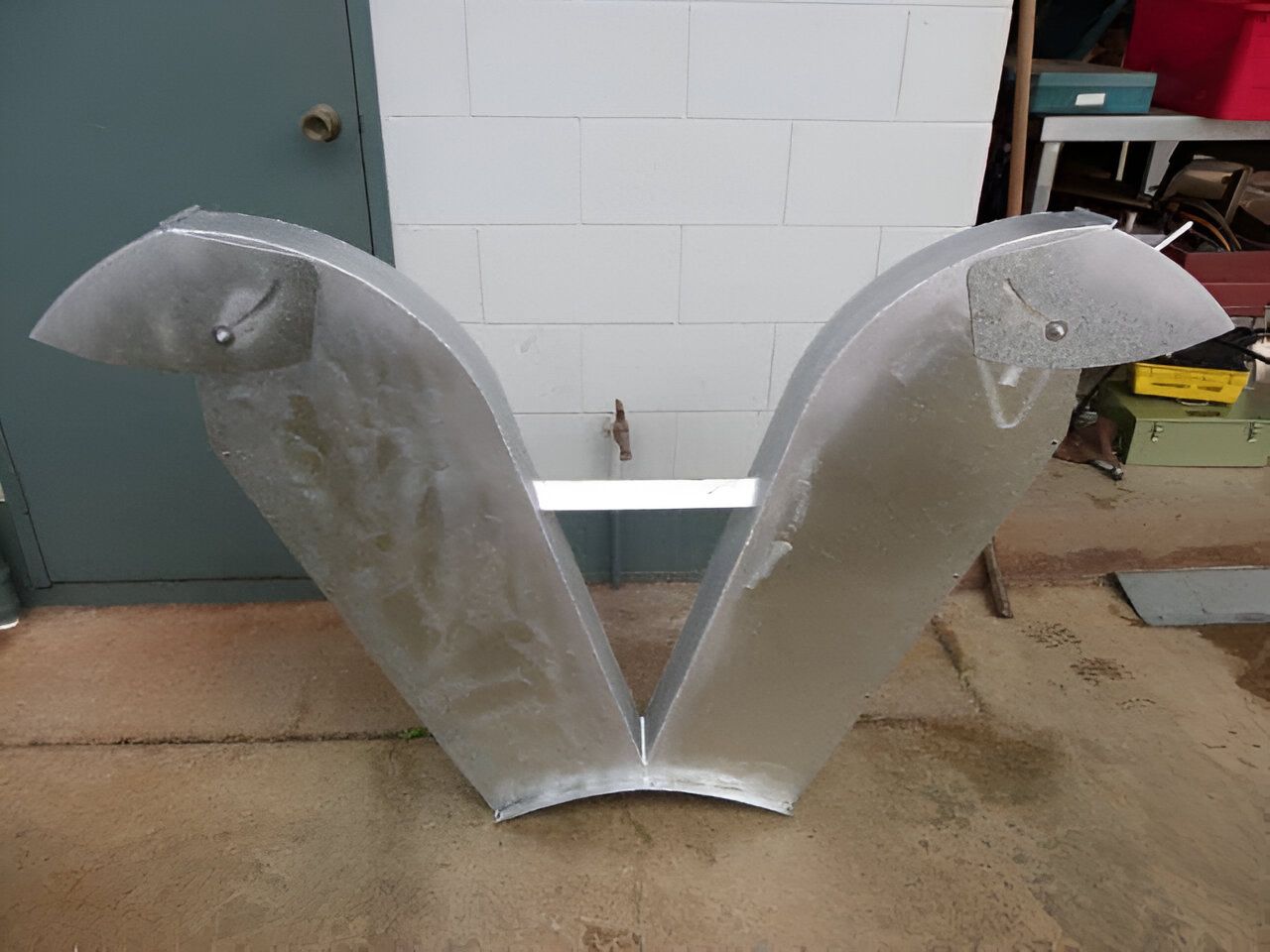 A Large Metal Object is Sitting in Front of a Brick Wall — Eclipse Fabrication in Atherton, QLD