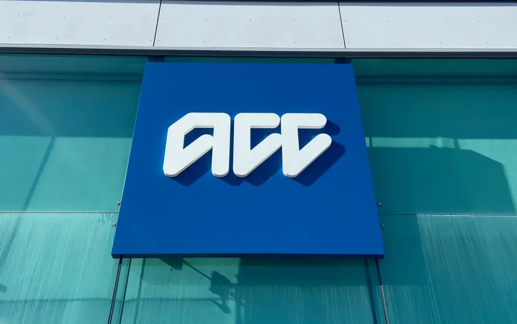 A blue sign on a building that says acc