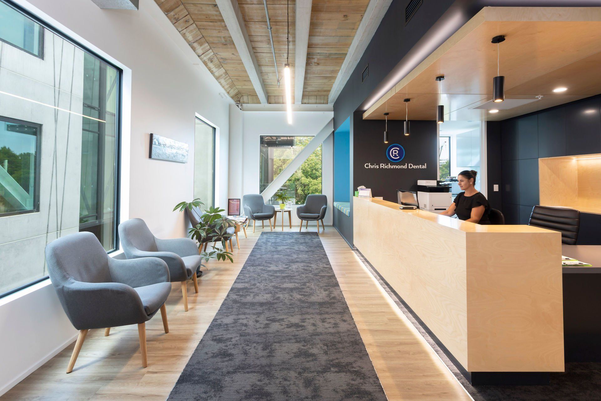 A man stands behind a counter in a waiting room