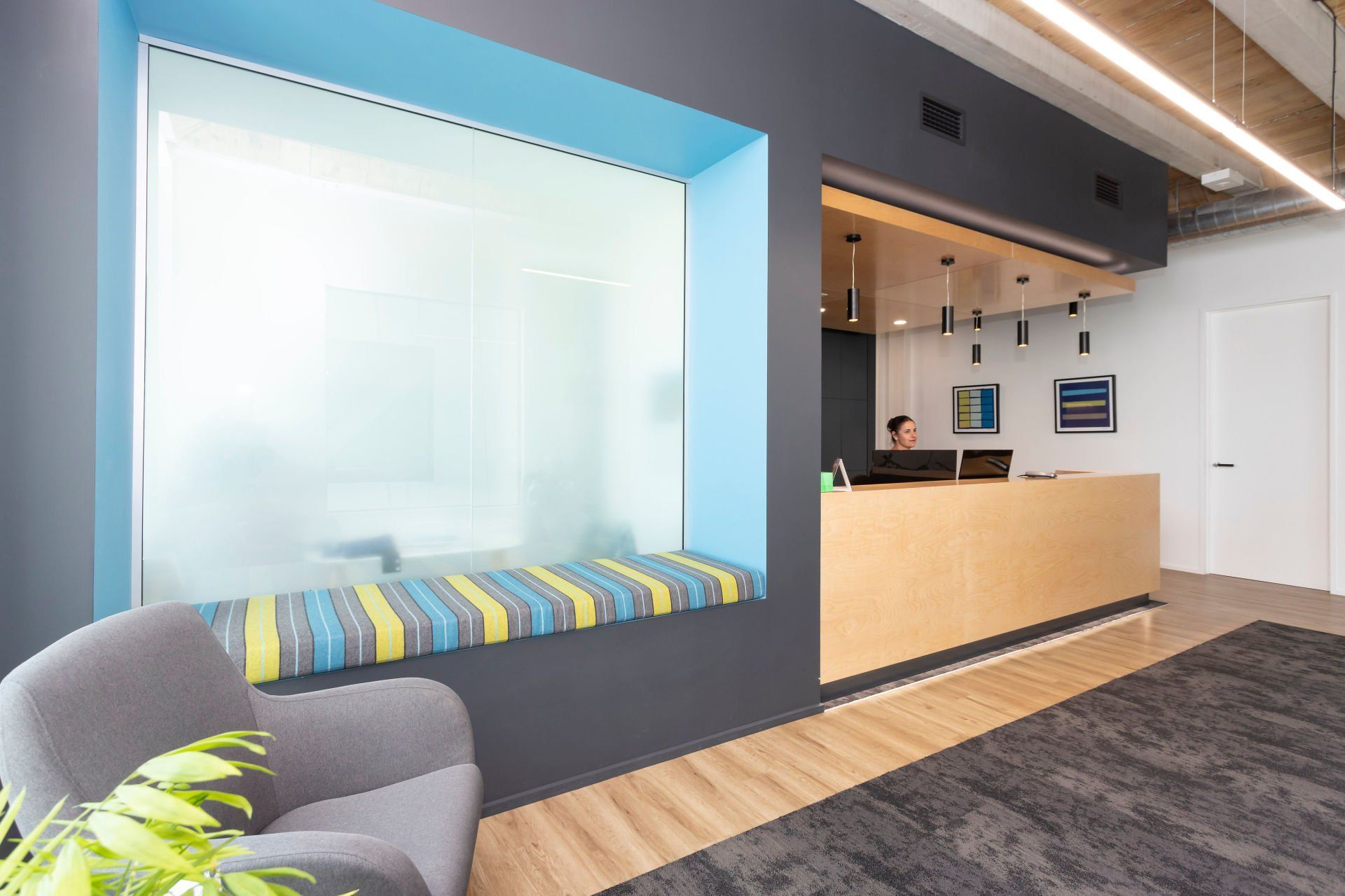 A reception area with a chair and a window