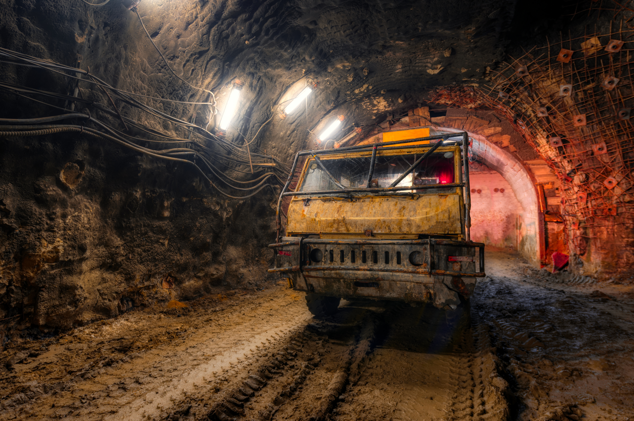 A Truck Is Driving Through A Tunnel In A Mine  — Secure Mine Solutions In  Ryan, QLD