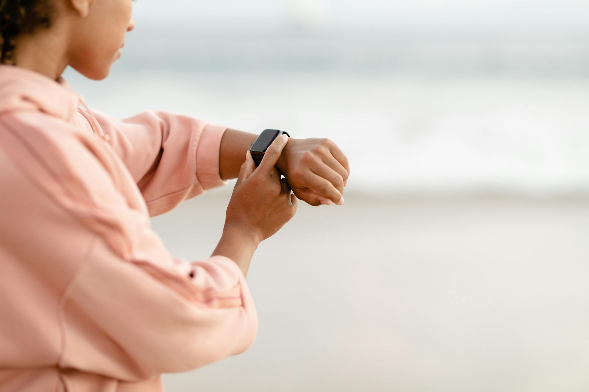 A woman looking at her fitness watch
