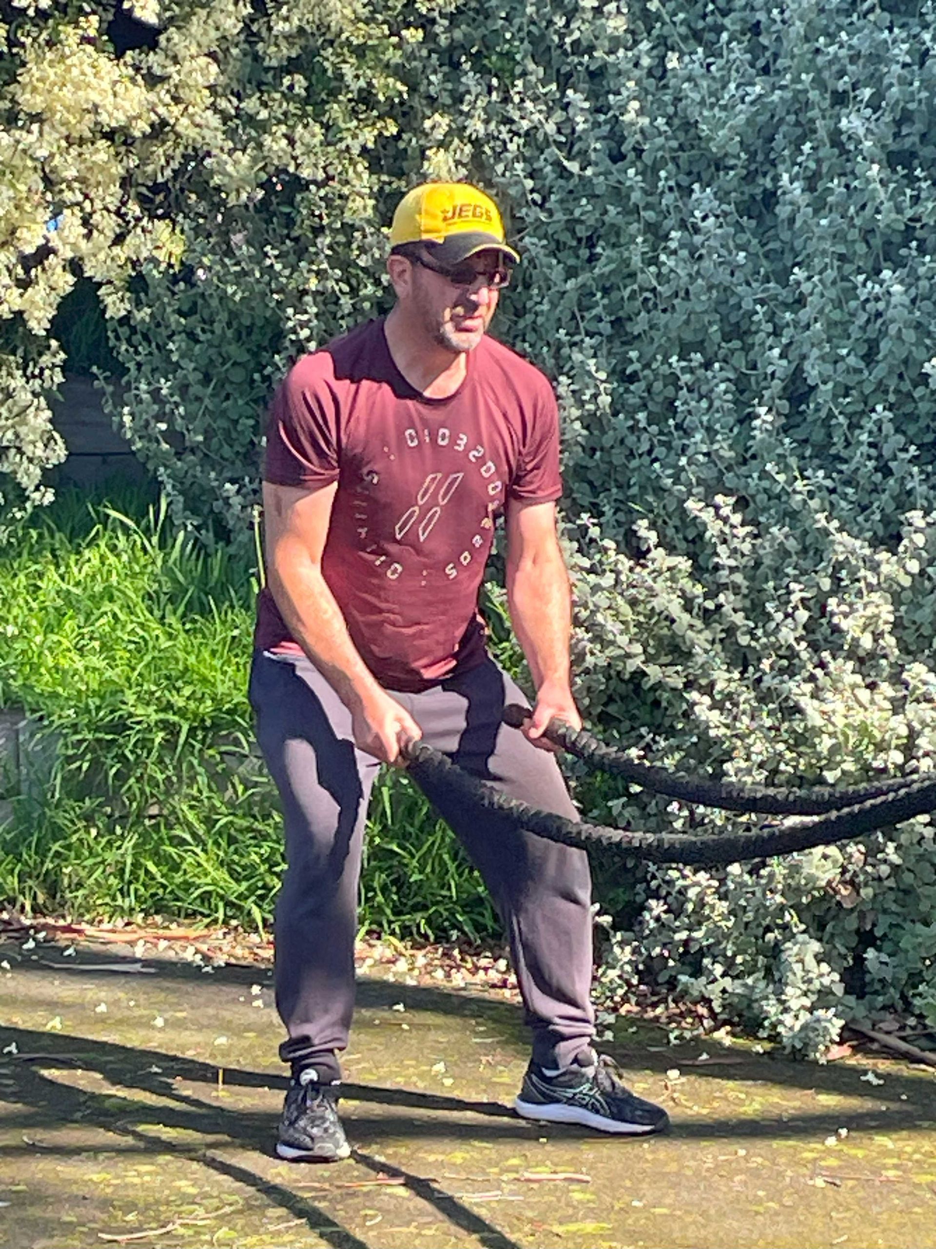 Members using battle rope as part of obstacle course