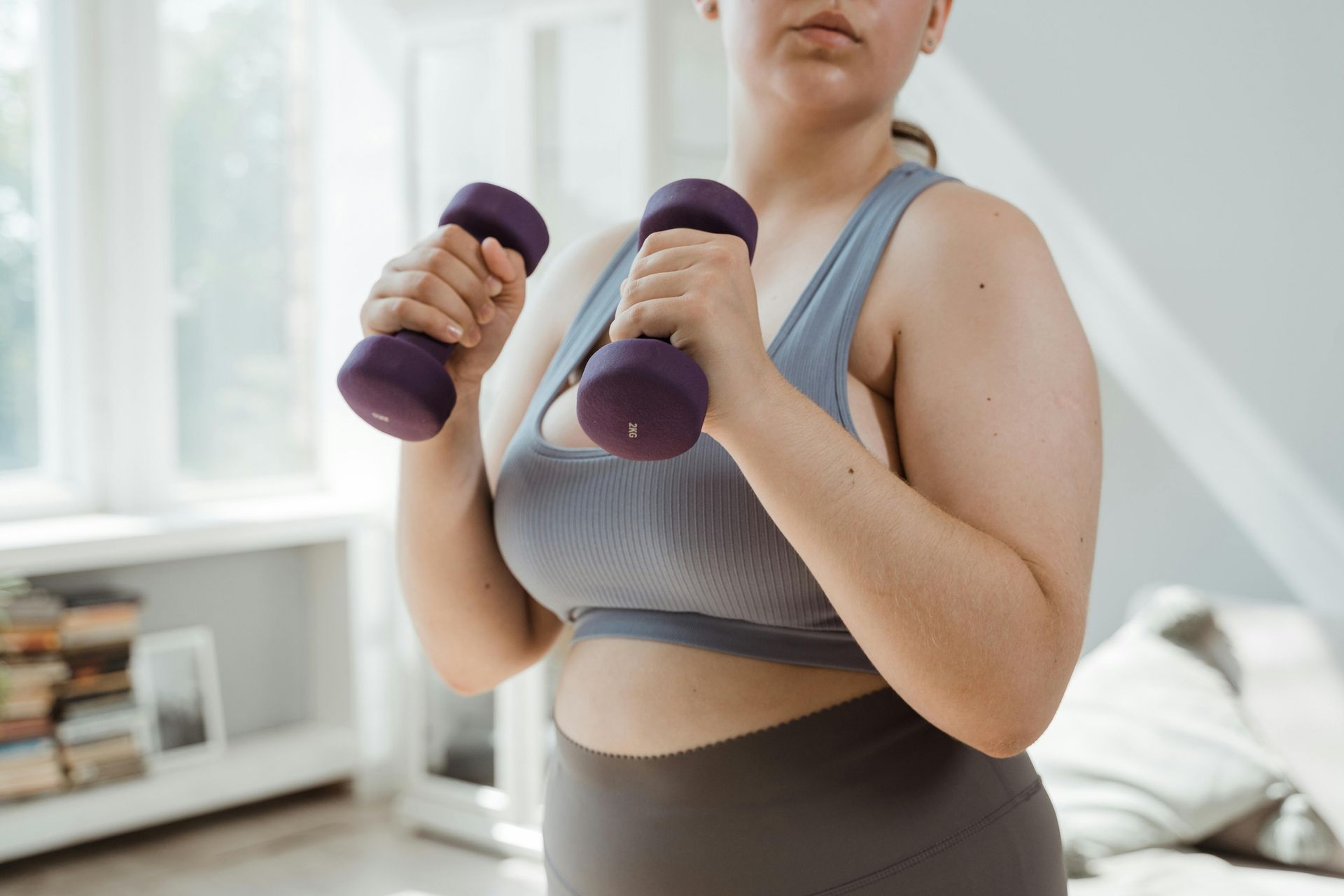 A woman working out with a set of dumbells
