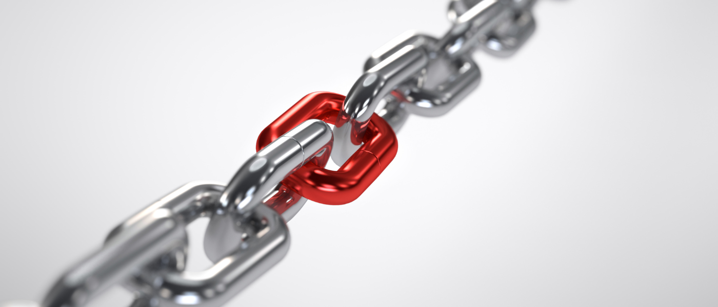 A photo of a chain link with one link being red and the rest being silver. The photo resembles backlinks for websites.
