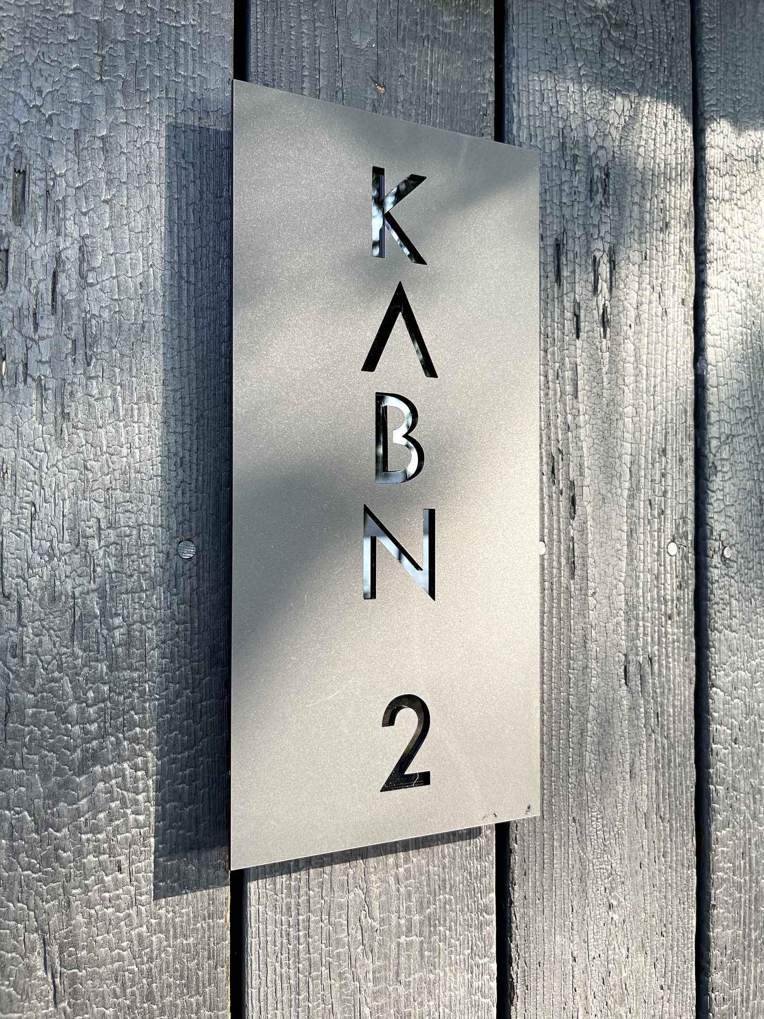 Kabn sign on charred timber.