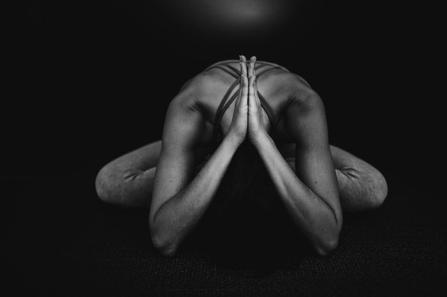 Female in yoga pose in a cabin.