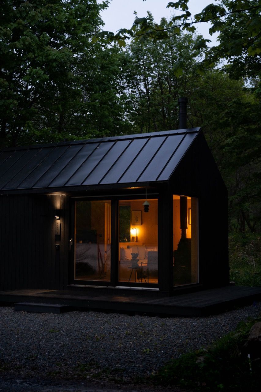 Black luxury cabin exterior at dusk.
