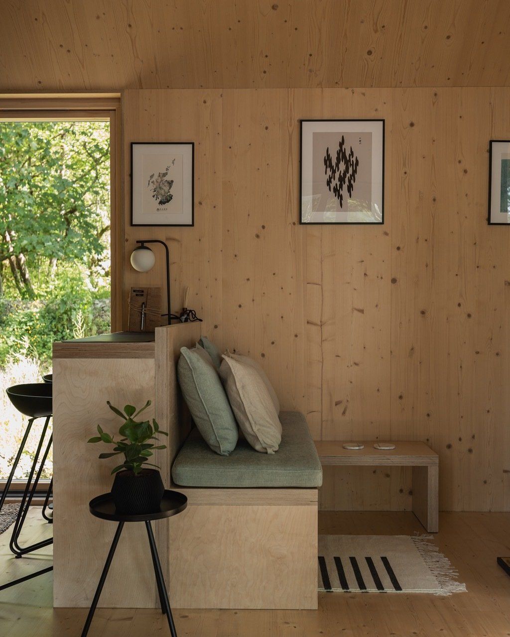 Luxury cabin interior showing a bench sofa and breakfast bar.