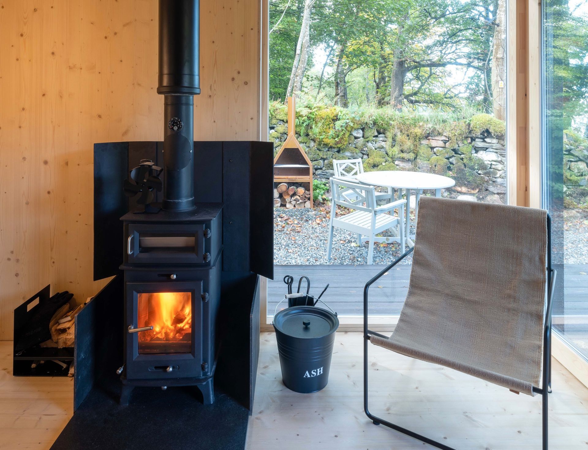 Wood burning stove alight in cosy cabin.