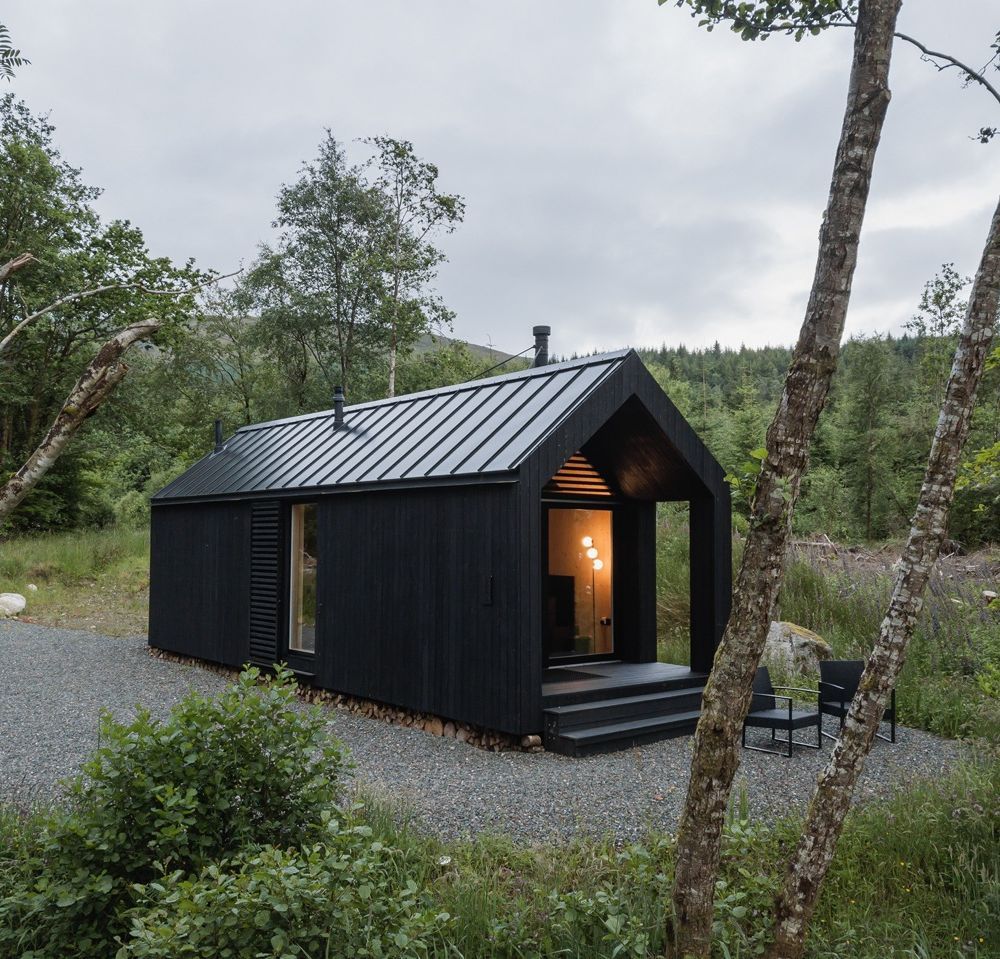 Pitched black Japanese cabin in Scotland surrounded by nature.